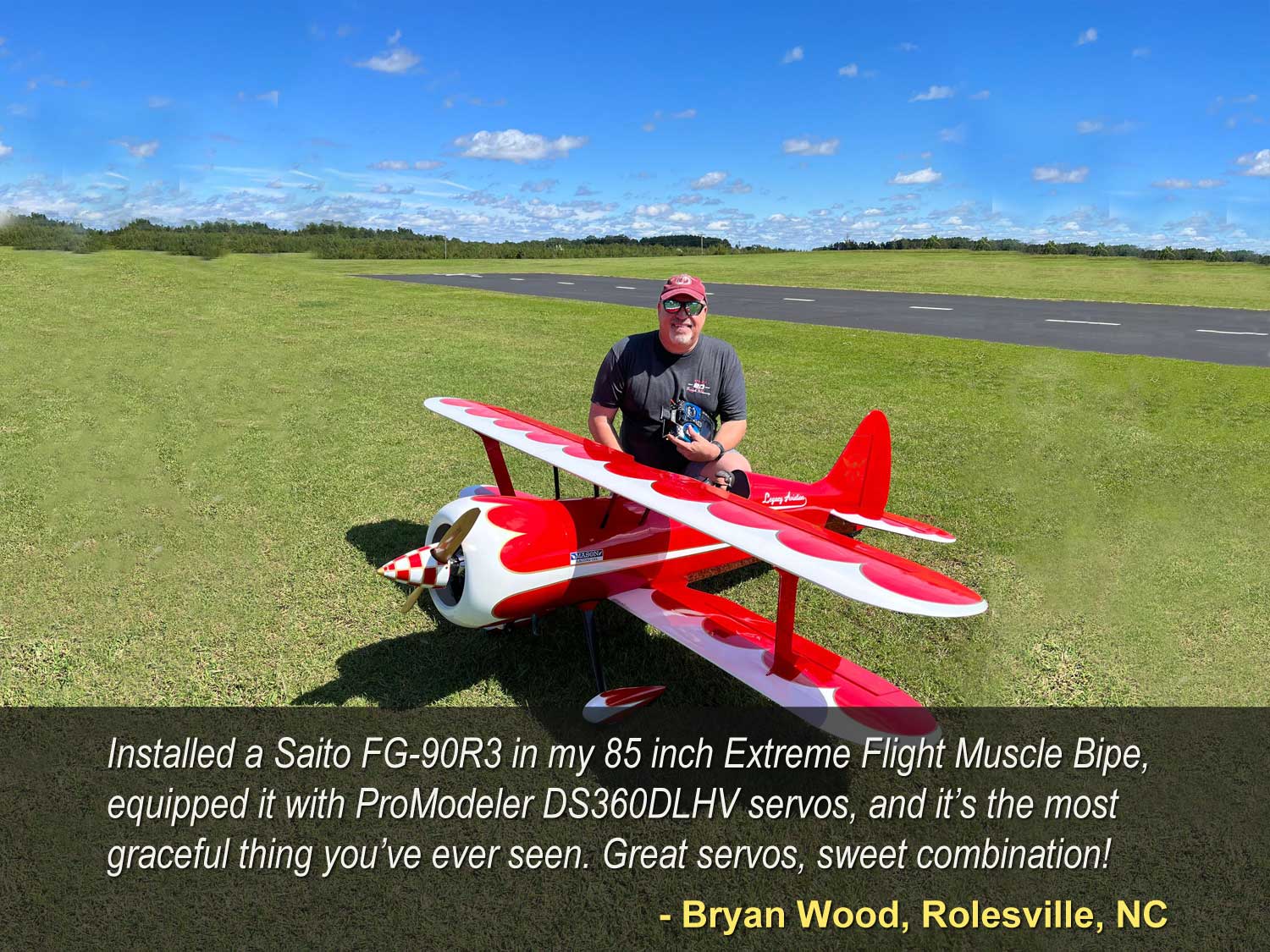 Field photo of Bryan Wood proudly showing off his Extrme Flight Muscle Bipe powered by Saito FG90R# and equipped with what many consider the world's best servo, the ProModeler DS360DLHV servos
