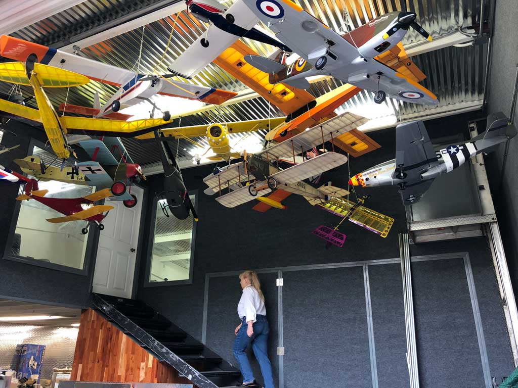 Wide angle photo of RC model airplanes suspended fomr the ceiling for display