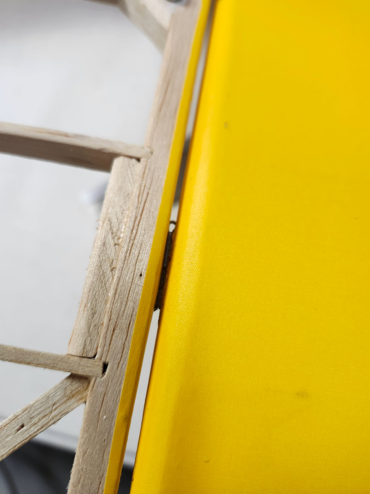 Close up photo of Oracover trimmed back near the hinge line to facilitate applying new covering