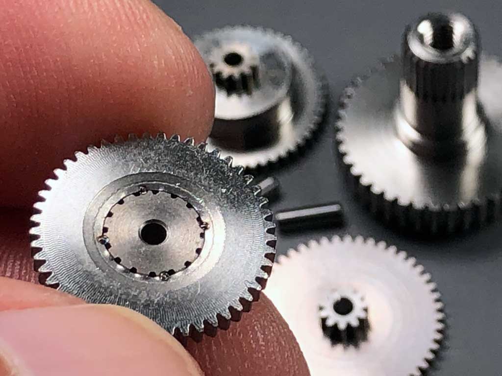 Close up photo of the gearset for a ProModeler DS210CLHV mini-class servo, which features a stainless steel gearset with spot welds between bull and pinion gears