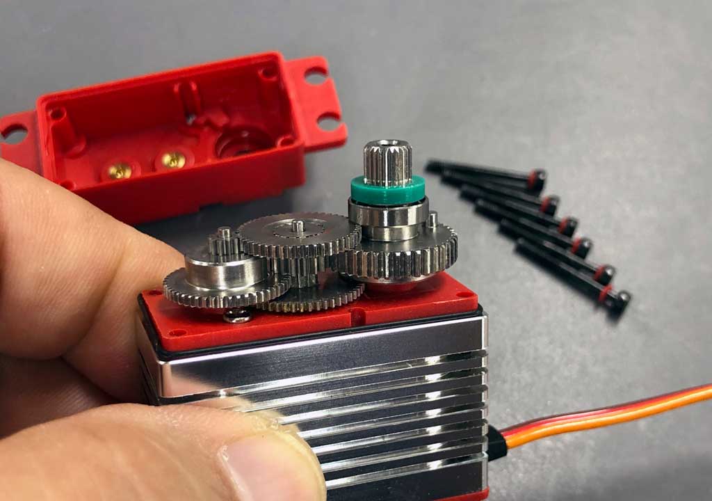 Photo of a hand holding a ProModeler DS90DLHV with the transmission gear train exposed to view
