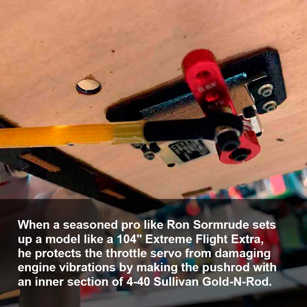 Close up photo demonstrating the best practice for a throttle linkage when forced into mounting on the engine, or motor box by using a short section of inner Sullivan Gold-N-Rod instead of a steel pushrod to better manage vibration entering the servo