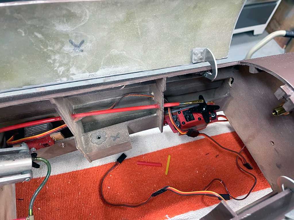 Close up pohto of how master builder Mark Armbrust mounted the throttle servo in his twin engine replica of the famous Fokker G1 by relying on distance and a Sullivan Gold-N-Rod for making the linkage to help preclude vibration induced damage to his throttle servos
