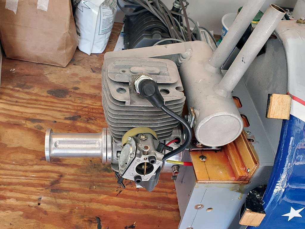 Close up photo demonstrating the use of a Bowden cable (in the form of a Supllivan Gold-N-Rod for throttle control of a Zenoah G-62 engine mounted within Jim Simonitch's giant scale P-47 model