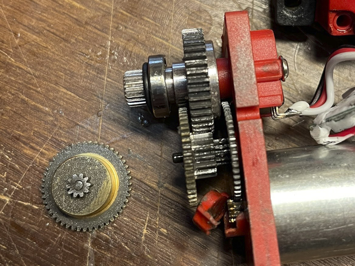 Close up of a failed throttle servo where vibration was so prevalent the gears themselves began to disintegrate and resulted in gear dust embedded in grease accelerating wear and resulting in so much backlash the palstic  case itself failed