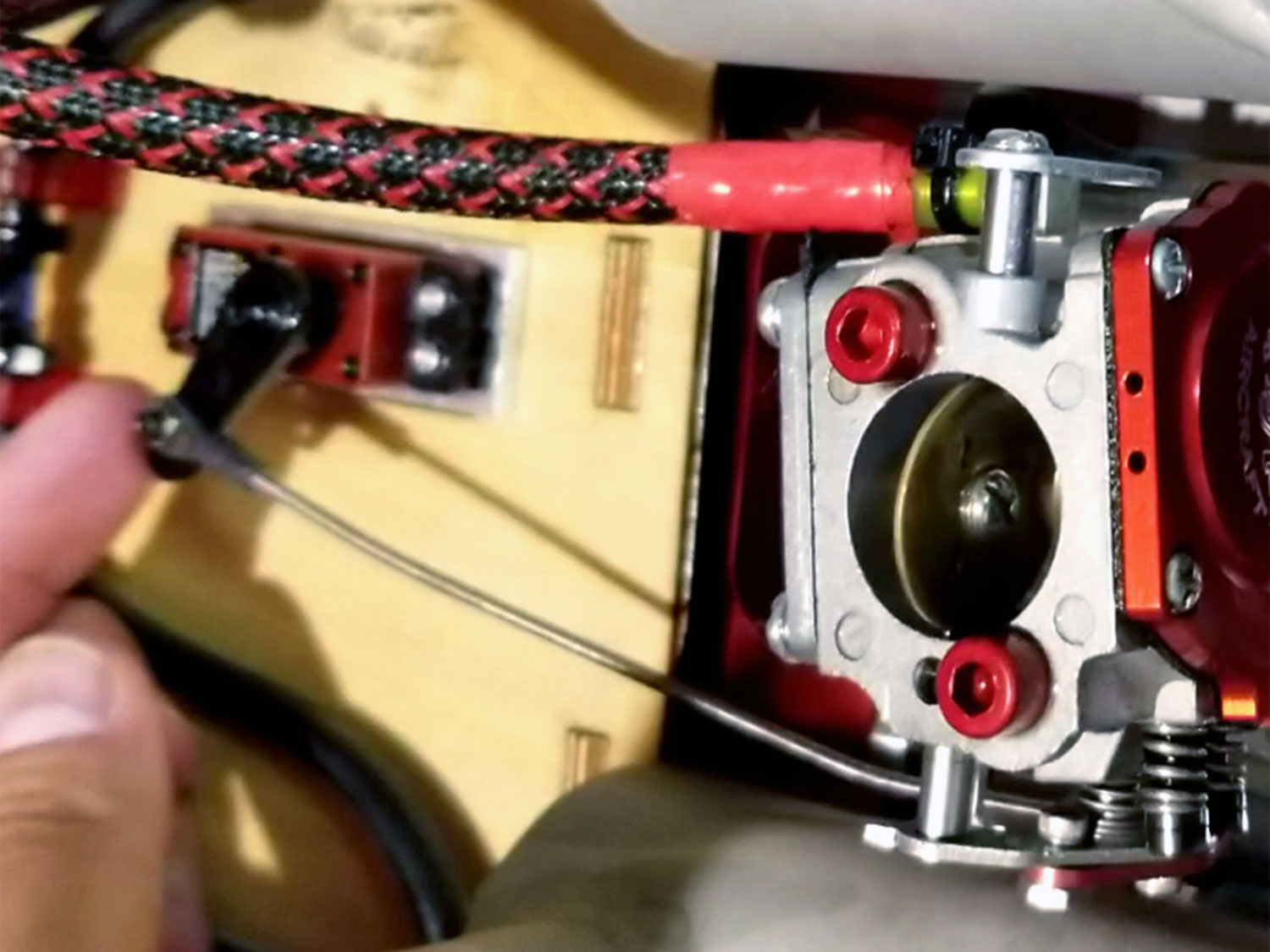 Close up of a ProModeler throttle servo mounted as far from the engine as possible within an engine nacell whilst using a Sullivan Gold-N-Rod to complete the linkage thusprotecting against excessive engine vibration