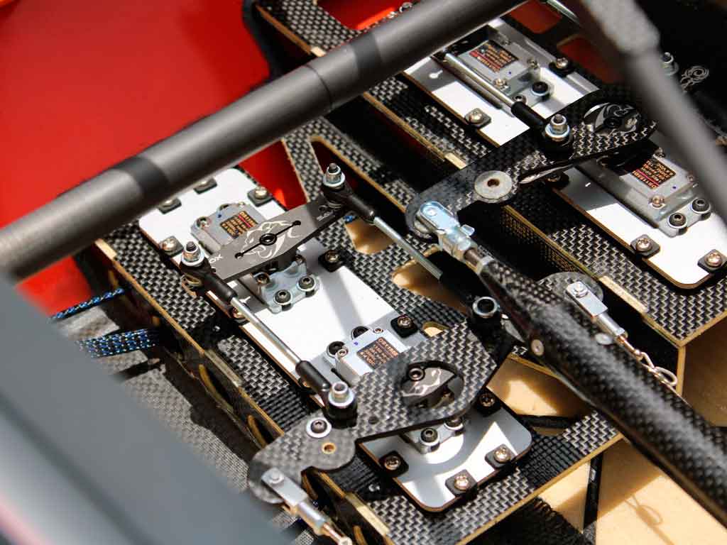 Extreme close up of the application of tiller (double-horn servo arms) to gang multiple servos together.