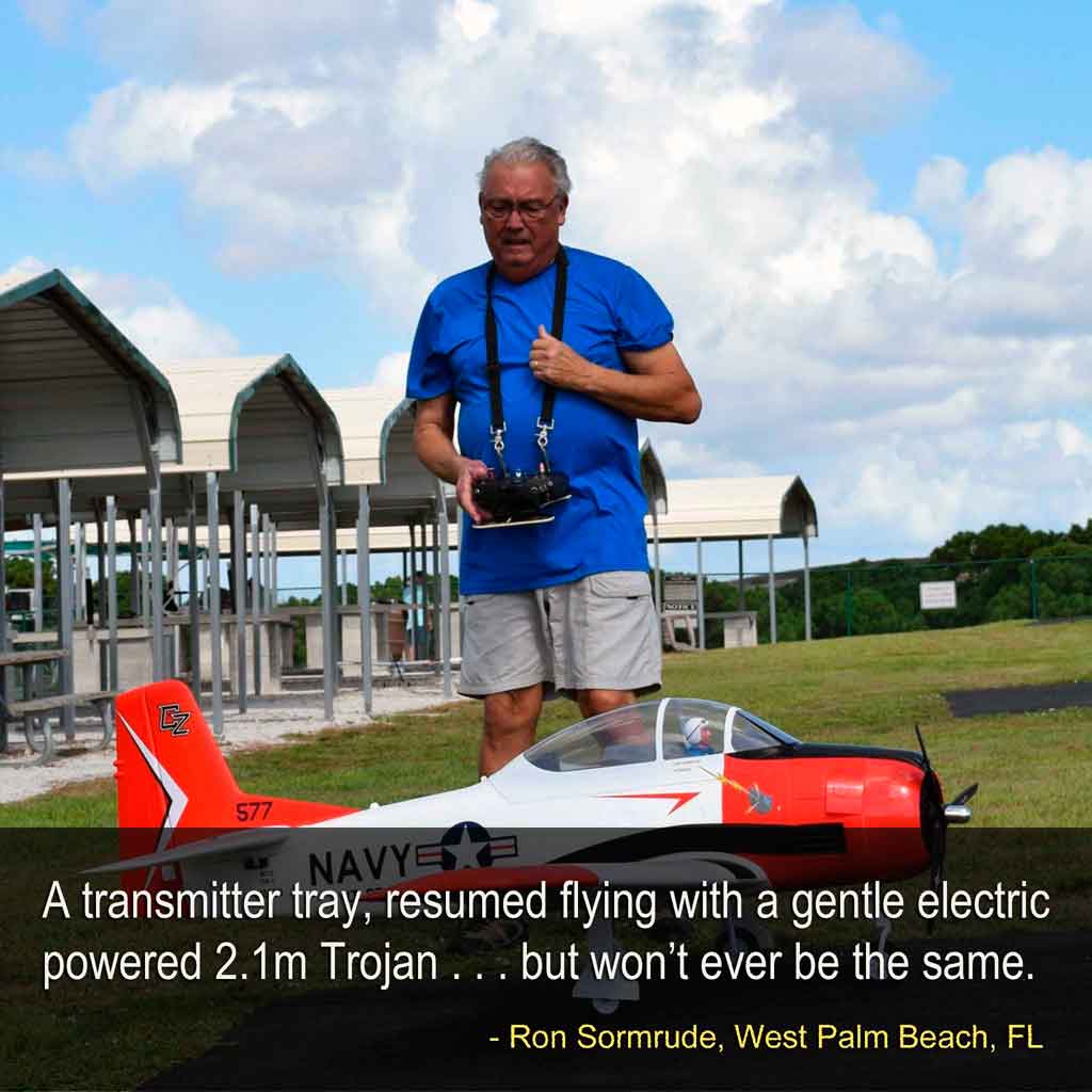 Ron standing behind his electric powered 2.1 meter Trojan with a radio tray to assist him with handling the transmitter