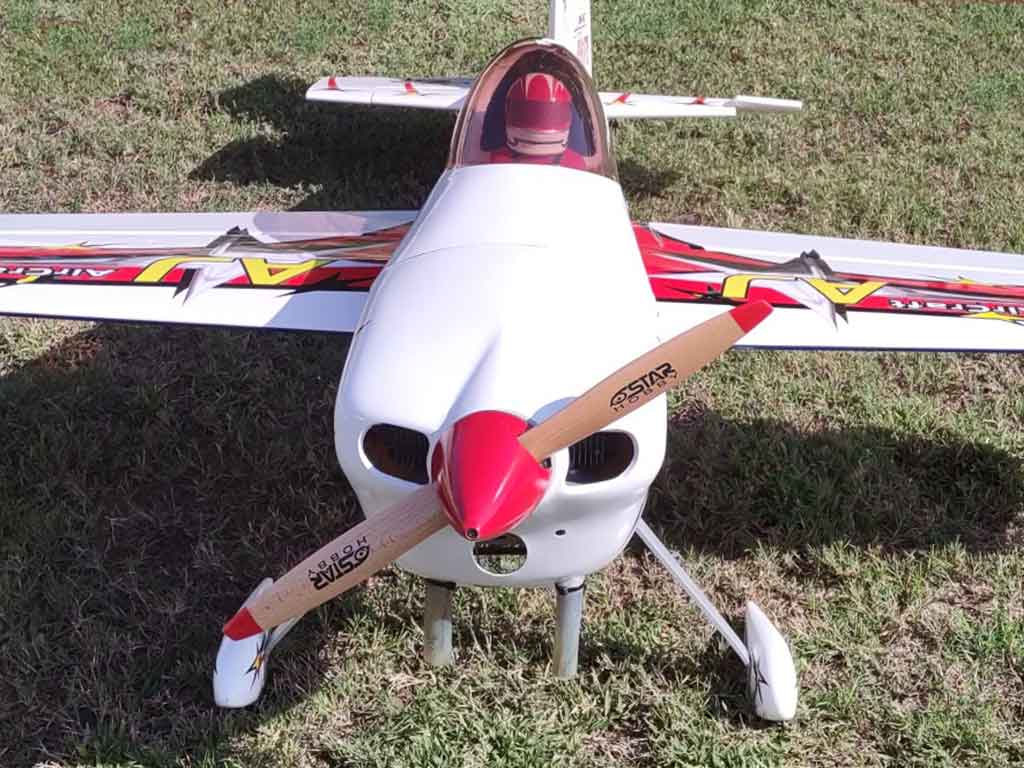 Close up shot of the business end of the AJ Models 83 inch Laser 230Z equipped with Star Hobby wooden prop with red tips and red spinner to match the color scheme.