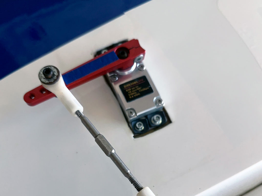 Close up of ProModeler DS630 servo in the aileron position of an AJ Models 93 inch Laser 230Z equipped with long red alloy servo arm with ball position at 1-1/2" on a 2" long horn, well suited for hot-IMAC maneuvers or mild-3D maneuvers.
