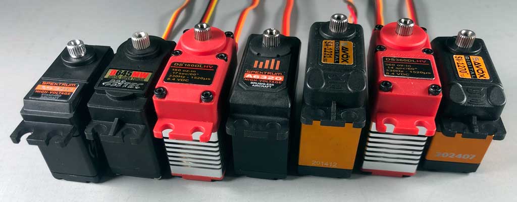 Close up of a series of platic top standard class servos ranging in output from 160oz-in through 624oz-in.