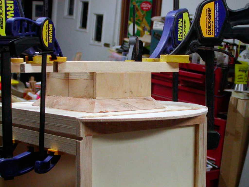 Close up of attaching the engine mounting box to the firewall. The job relies on epoxy and good clamps.