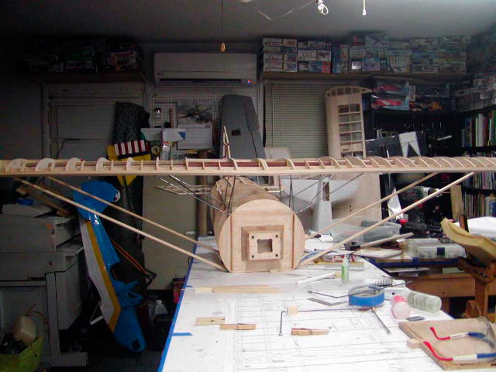 Dry fit of the major assemblies of a BUSA Morane-Saulnier model airplane showing the fuselage with wing and tail section attached.