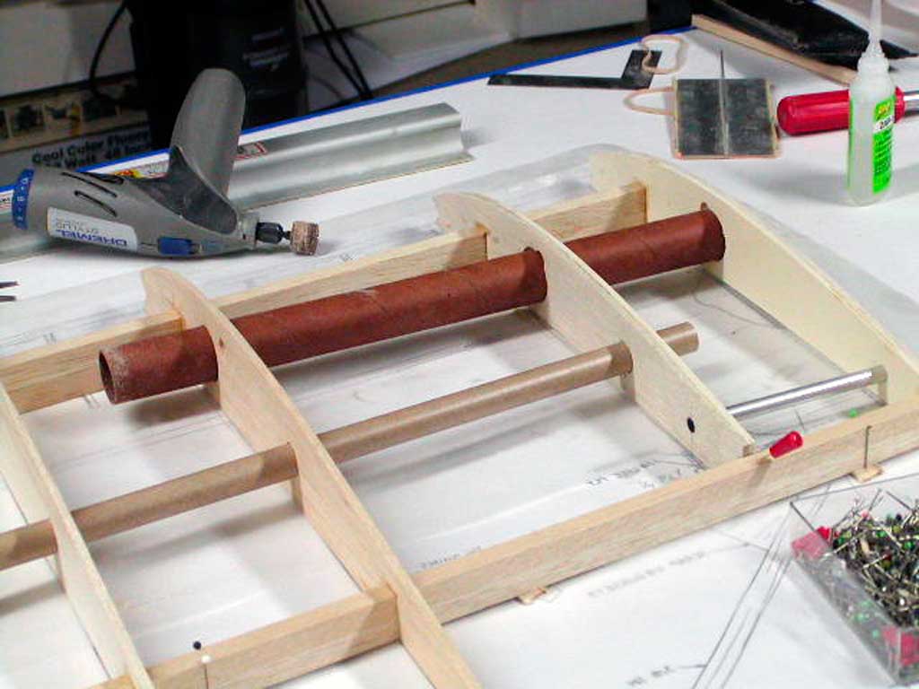 Close up showing balsa wood ribs placed on spars with wing joining tubes as well as tube for servo leads.