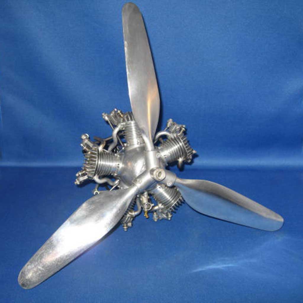 Close up of Morton M5 radial engine against a blue backdrop equipped with very rare 3-blade alloy propeller.