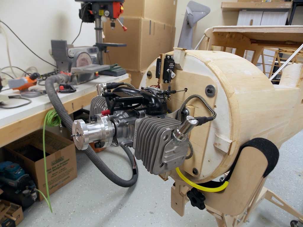 Close up of Nosen Mister Mulligan firewall with Zenoah GT-80 twin fitted to a removable power package incorporating fuel tank and servo after sliding it home and securing with bolts.