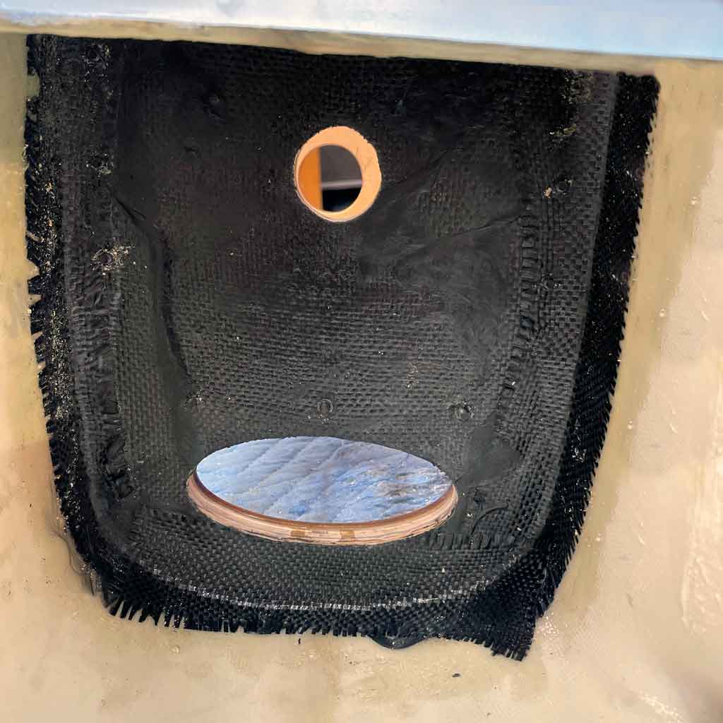 Close up of the final step in reinforcing the firewall of the CY Models 96" P-51 Mustang is adding a piece of carbon fiber cloth, thus sandwiching the new thicker firewall and tie it into the fuselage.