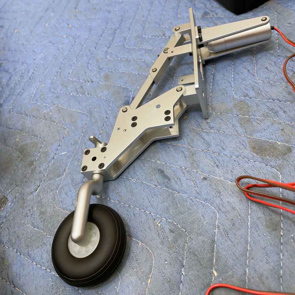 Close up of the electric retracting tail gear assembly for the CY Models P-51 Mustang includes scale looking wheel with rubber tire.