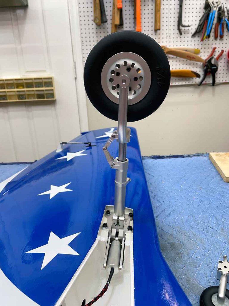 Close up of the electric main gear of the CY Models P-51 Mustang shows off the oleo-action strut and scale wheel.