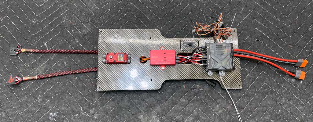 Detail photo of replacement equipment tray fabricated of carbon fiber board with servo, retract controller, and receiver fitted in place.