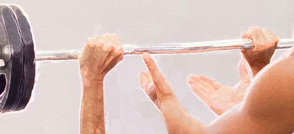 Image showing a barbell held by two hands with a spotter nearby