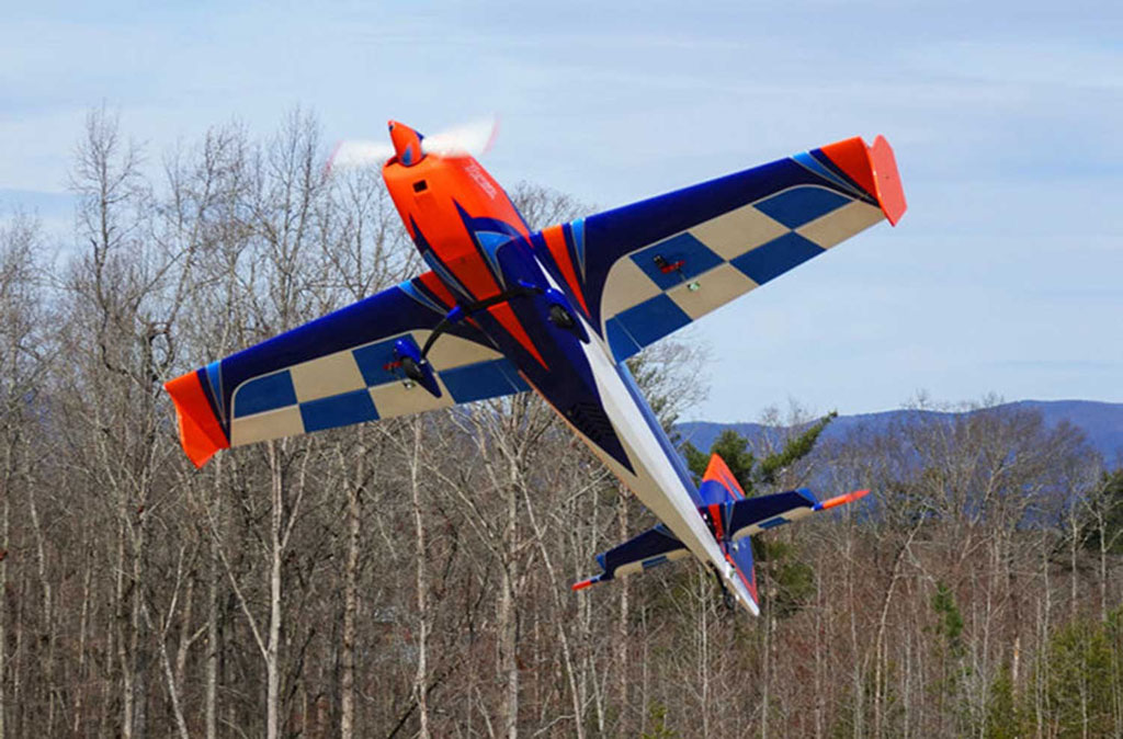 Wide angle photo of an Extreme Flight 85in Extra 300EXP in flight featuring one of their alternative color schemes