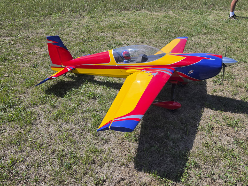 Side view photo of an Extreme Flight 85-inch Extra 300EXP against a grass background