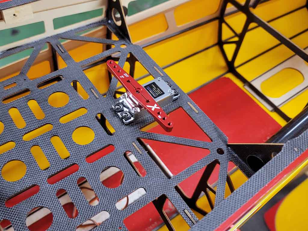 Close up photo of the rudder servo installation within an Extreme Flight 85 inch Extra 300EXP