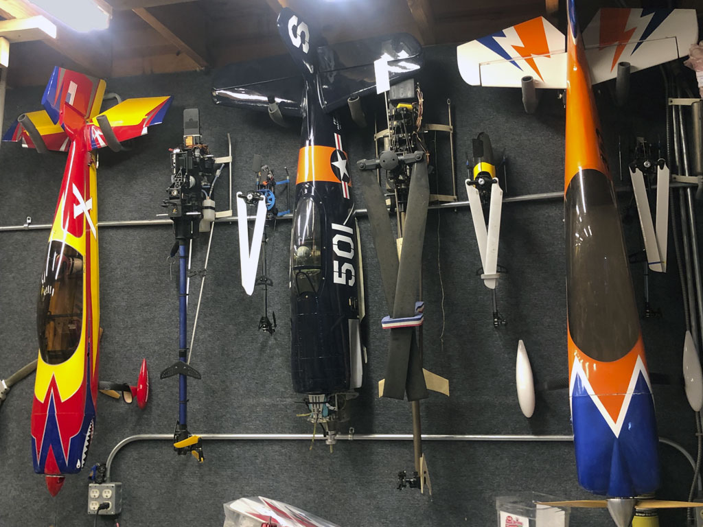 Photo of models suspended by their horizontal stabs on a workshop wall