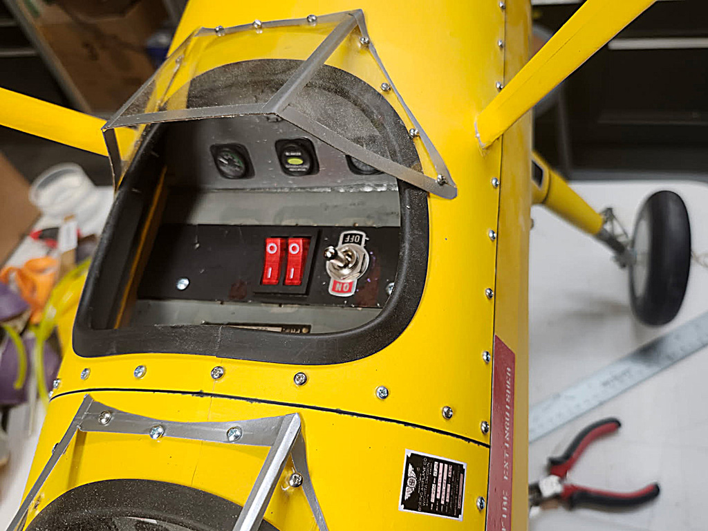 Photo of the front cockpit floor of a Stearman with a pair of switches installed
