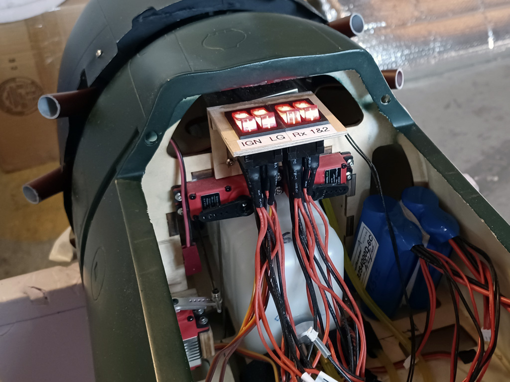 Dual dual-illuminated rocker switches mounted within a TopRC Zero fuselage for avionics, ignition, and electric retracts