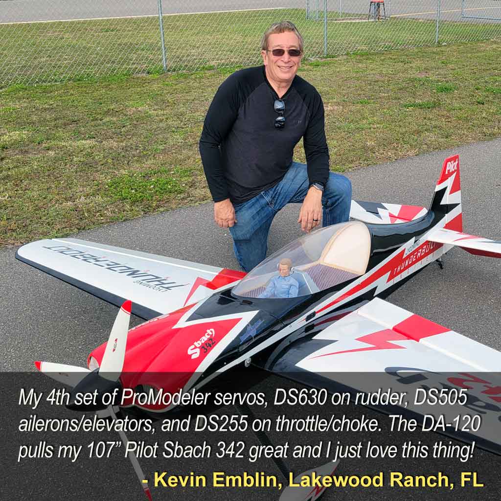 Satisfied ProModeler customer kneels besides his giant scale model airplane at a flying field