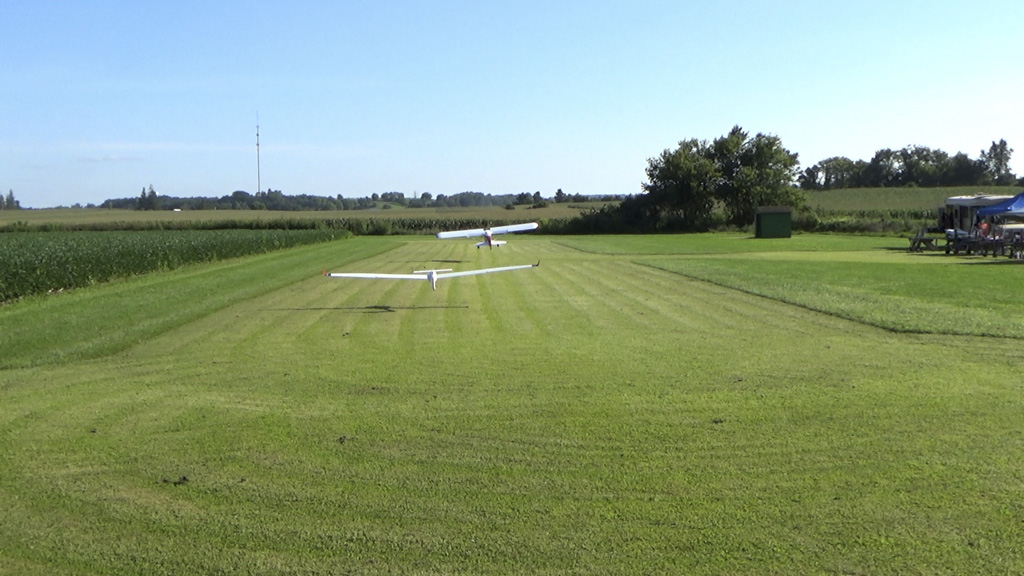 Photo from behind both tug and glider as they begin to really climb as the tug's angle of attack increases