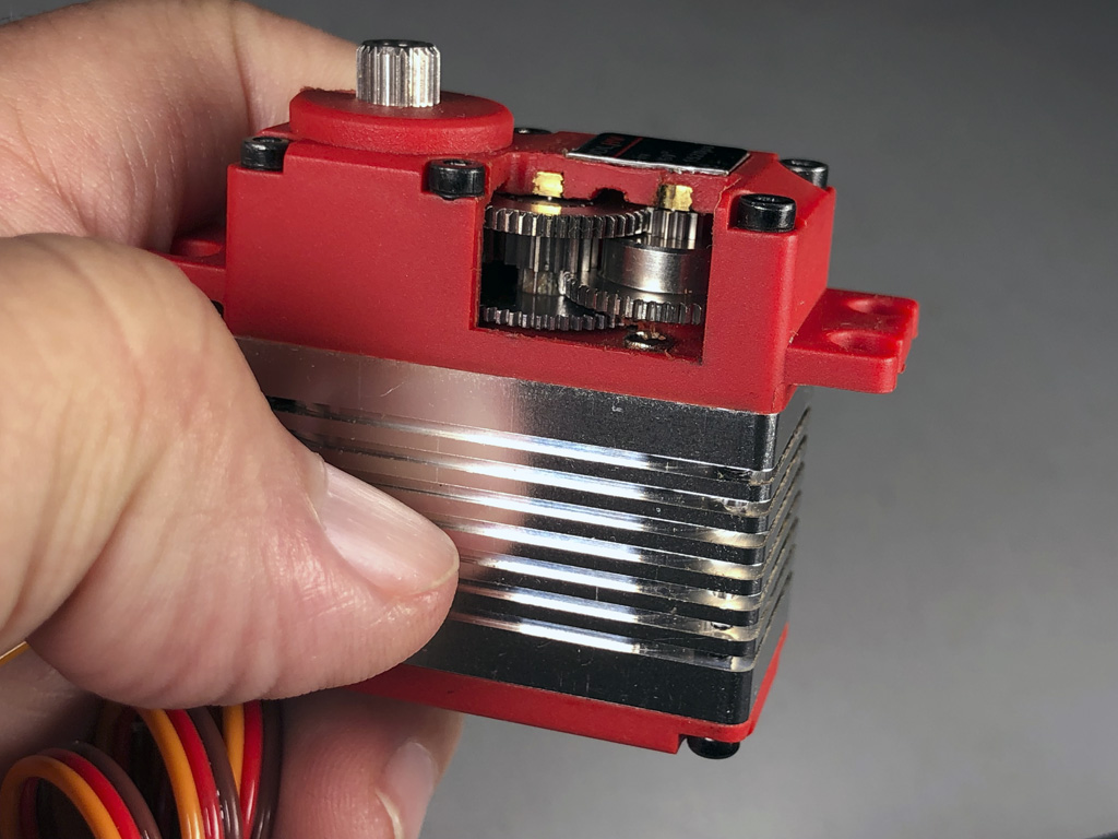 Close up photo of a servo cutaway providing a window into an assemble servo gear train
