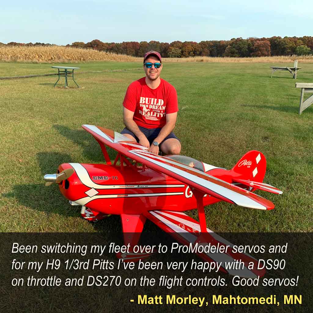 Matt Morley kneeling on grass behind his Hangar 9 Pitts equipped with ProModeler DS270DLHV servos on the control surfaces
