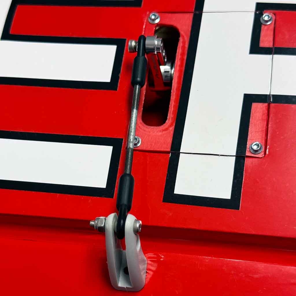 Close up of ProModeler DS930BLHV servo installed on a hatch with PDRS20-25T servo arm sticking through and connected to an aileron linkage rod to the control surface.