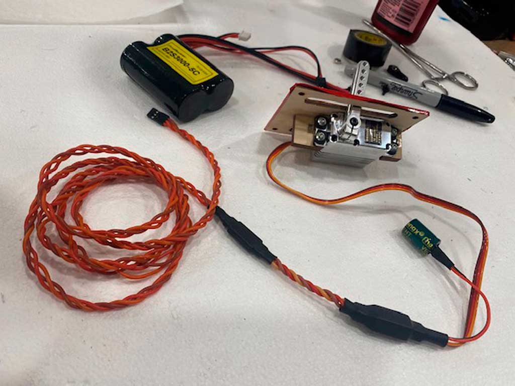 Image showing a servo mounted sideways on a plywood plate