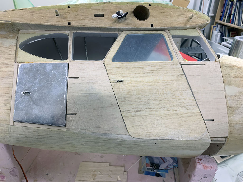 Close up photo of the fusleage construction of the Hostetler quarter scale Cessna 195 showing the baggage and cabin doors installed