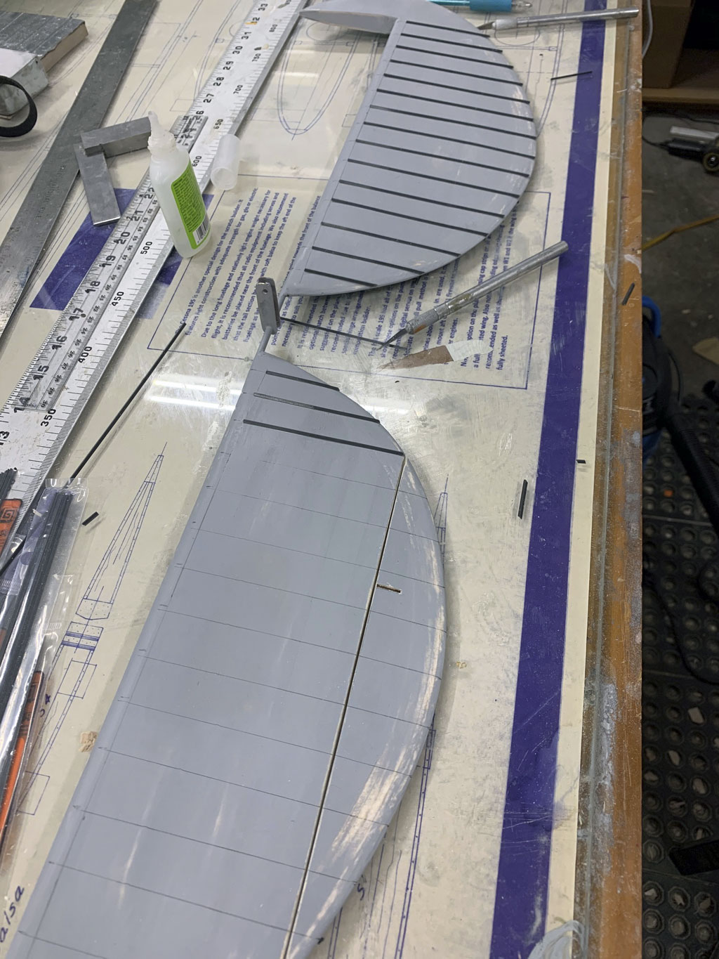 Close up photo of the stabs being detailed and covered in Flite-Metal for a Hostetler quarter scale Cessna 195 by gluing the corrugations
