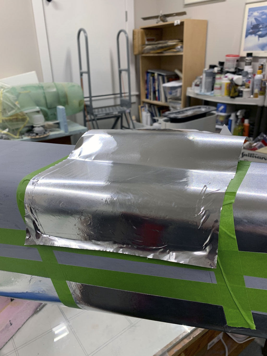 Close up photo of the fuselage construction of the Hostetler quarter scale Cessna 195 showing a piece of Flite-Metal being trimmed and burnished in place