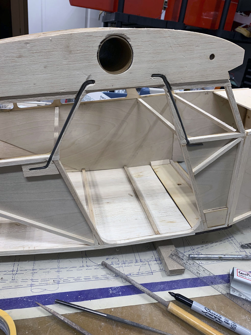 Close up photo of the fusleage construction of the Hostetler quarter scale Cessna 195 using wire to reinforce the cabin door opening