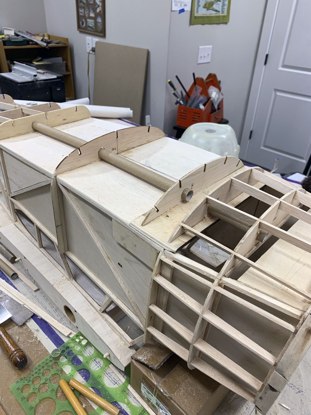 Close up photo of the bottom of the fusleage construction of the Hostetler quarter scale Cessna 195 shwowing the cardboard tube used to route throttle leads to the receiver