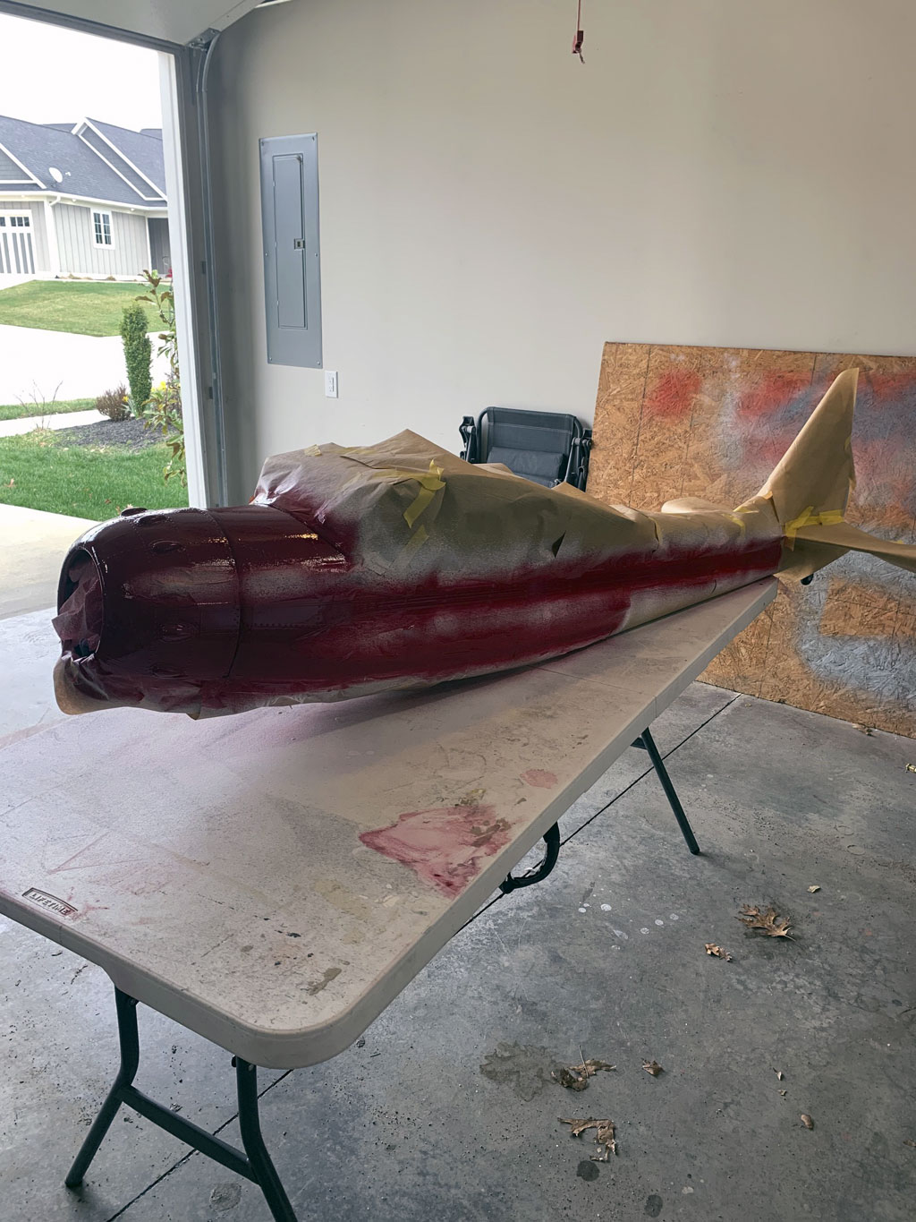 Wide angle photo of Hostetler Cessna 195 sprayed with the maroon paint