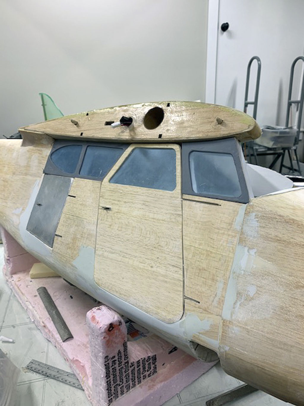 Close up photo of the fuselage construction of the Hostetler quarter scale Cessna 195 showing the plywood and glazing installed
