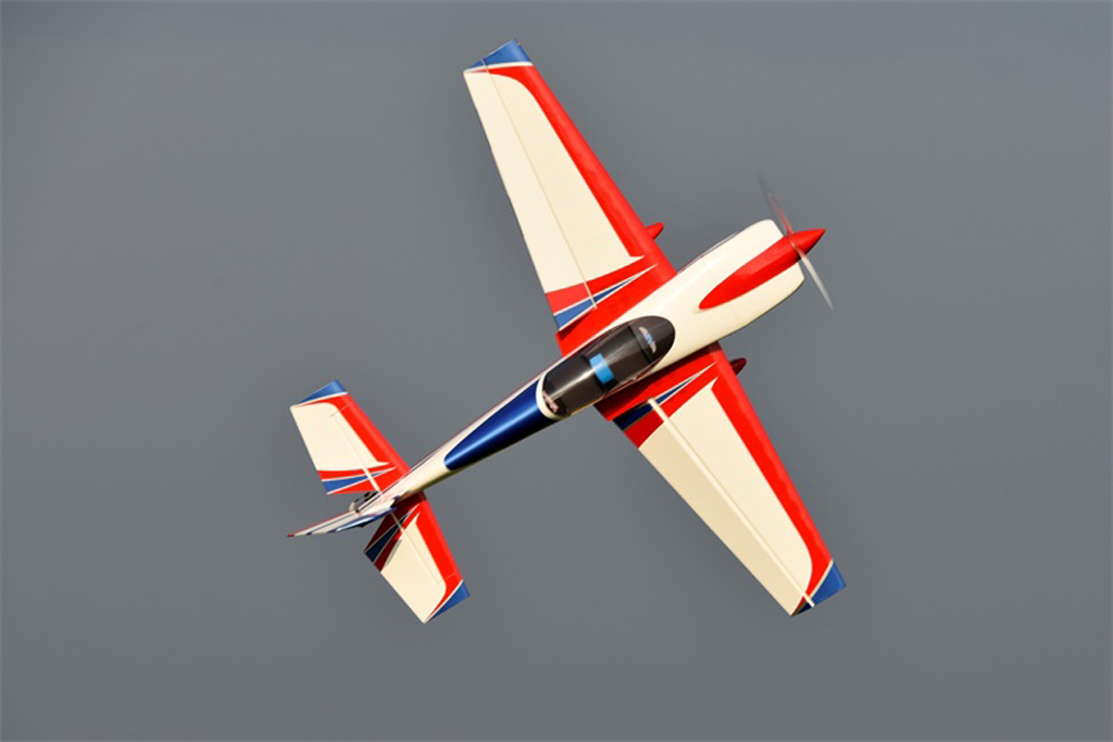 Photo of an RC Skywing 116in Extra NG performing a slow speed knife edge pass