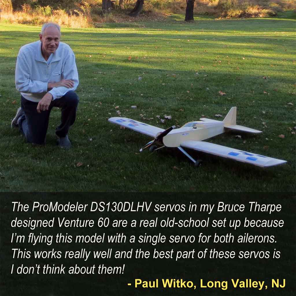 Modeler kneeling with his model airplane in the backyard.