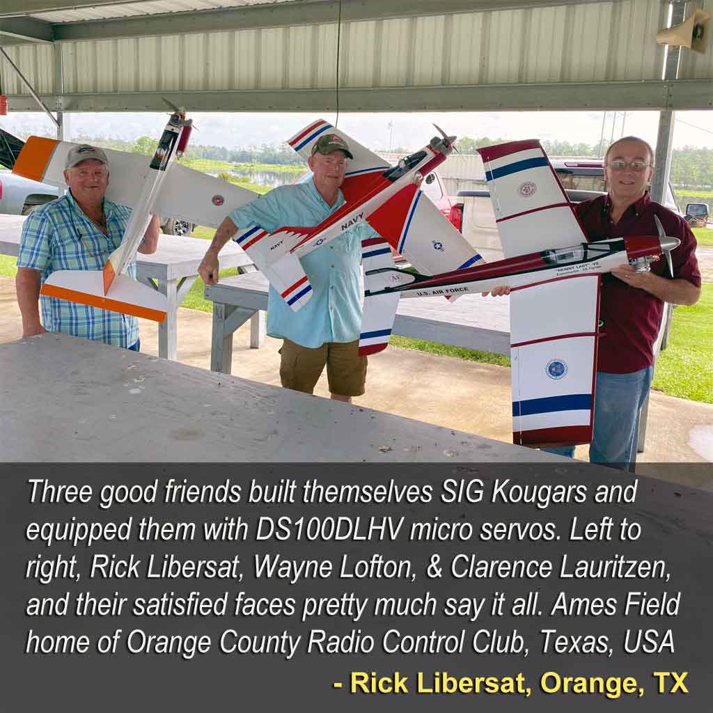 Three friends holding SIG Kougar model airplanes.