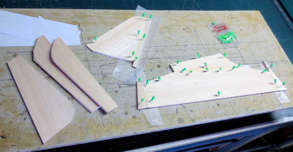 Close up of the vertical and horizontal stab components of a SIG Four-Star 40 balsa wood model.