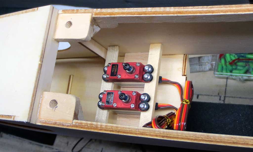 Close up of two DS100DLHV micro servos installed within the SIG Four-Star 40 fuselage for rudder and elevator function.