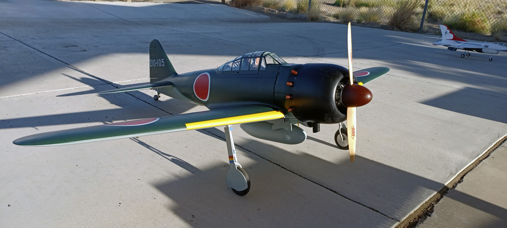 Wide angle photo of the TopRC Models 5th scale A6M5 Zero on the flight line